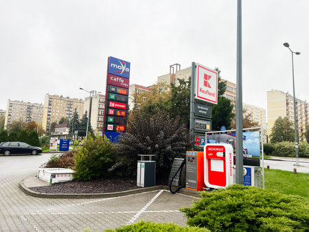 Tarnow, Poland - October 25, 2025: A street scene with Moya gas station, fuel pumps, and a Kaufland sign amid city buildings in Tarnow, Poland.のeditorial素材