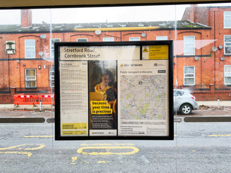 Manchester, UK - November 15, 2025: Public transport display at a Manchester street with timetable and map panels.のeditorial素材