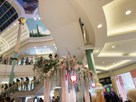 Stretford, UK - November 15, 2025: Vibrant Trafford Centre shopping centre interior in Manchester UK with cascading flowers, arches, and shoppers enjoying a festive atmosphere.のeditorial素材
