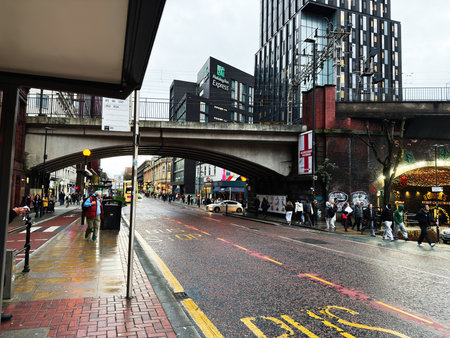 Manchester, UK - November 27, 2025: Urban street in Manchester UK with pedestrians, buses, and festive lights.のeditorial素材
