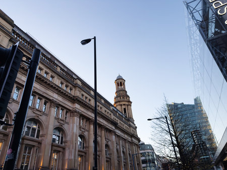 Manchester, UK - November 19, 2025: Historic and contemporary architecture in Manchester city center, featuring a clock tower and glass facade.のeditorial素材