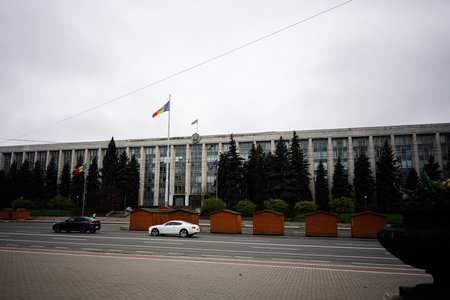 Chisinau, Moldova - November 22, 2025: Chisinau Moldova government building with flags, trees, and...
