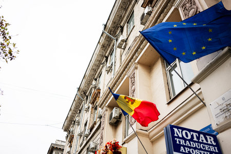 Chisinau, Moldova - November 22, 2025: Flags of the European Union and Moldova flutter outside a...
