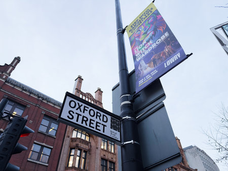 Manchester, UK - December 10, 2025: A street view in Manchester featuring the Oxford Street sign, lampposts, and promotional banners.のeditorial素材