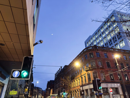 Manchester, UK - December 10, 2025: Evening cityscape in Manchester showing brick historic building...