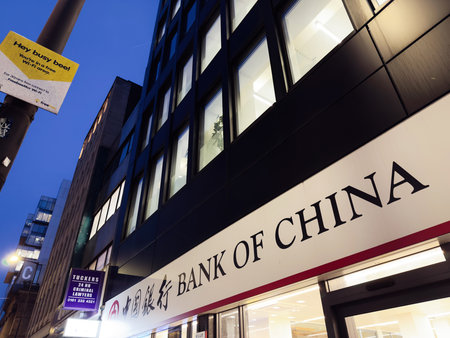 Manchester, UK - December 10, 2025: Bank of China exterior in Manchester, nighttime urban scene with glass building and signage.のeditorial素材