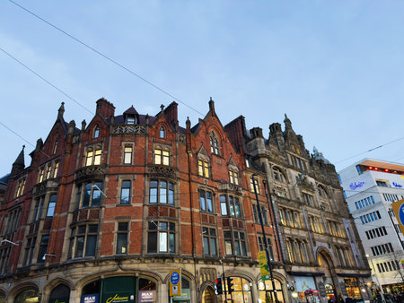 Manchester, UK - December 10, 2025: Row of ornate red brick buildings with shopfronts in Cross st, Manchester, UK, at twilight.のeditorial素材