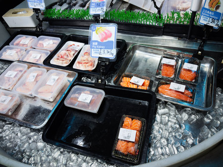 Manchester, UK - December 10, 2025: Assorted Blue Whale seafood and meat on ice in a refrigerated display at a Manchester market seafood counter.のeditorial素材