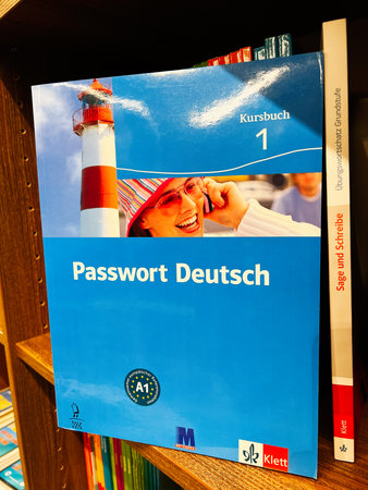 London, UK - December 12, 2025: Blue German language course book cover with lighthouse and cheerful student, educational travel theme.のeditorial素材