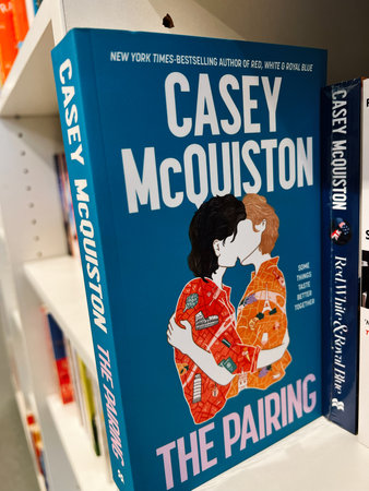 London, UK - December 12, 2025: Blue book cover shows two people kissing; romance novel vibe with...
