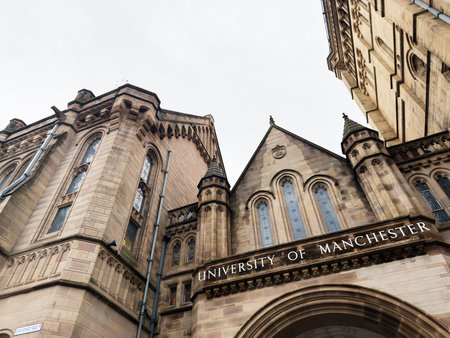 Manchester, UK - December 06, 2025: Impressive university architecture with Gothic arches and stone facade in Manchester, UK.のeditorial素材