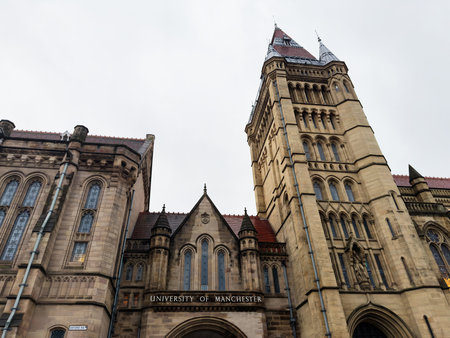 Manchester, UK - December 06, 2025: Historic university building with a tall tower and arched windows in Manchester, UK.のeditorial素材