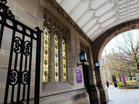 Manchester, UK - December 06, 2025: Arched entrance, lanterns, and decorative stained glass create a...