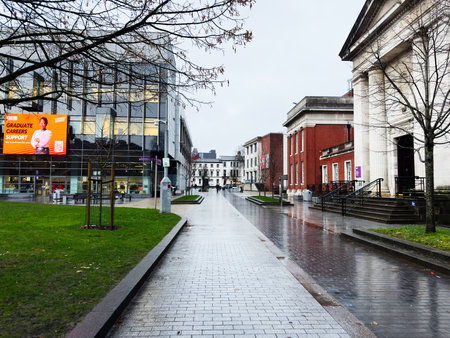 Manchester, UK - December 06, 2025: Rainy day on a Manchester campus with modern glass building and...