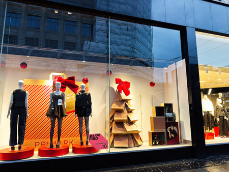 Manchester, UK - December 01, 2025: Stylish window display in Manchester featuring three mannequins,...