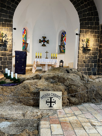Tabgha, Israel - December 03, 2022: Rocky church interior in Israel featuring an altar, candles,...