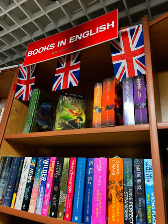 Lviv, Ukraine - November 29, 2025: Bright bookshelf scene featuring English books with Union Jack...