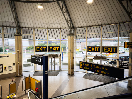 Manchester, UK - January 12, 2026: Inside a modern Manchester airport transit station, bright yellow...