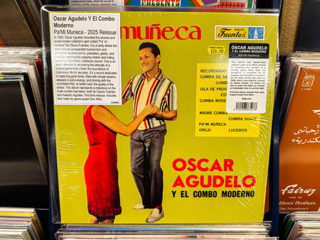 Manchester, UK - January 21, 2026: Vibrant yellow cover featuring a man and woman dancing, retro cumbia revival artwork. Oscar Agudelo y El Combo Moderno Pa'mi Munecaのeditorial素材
