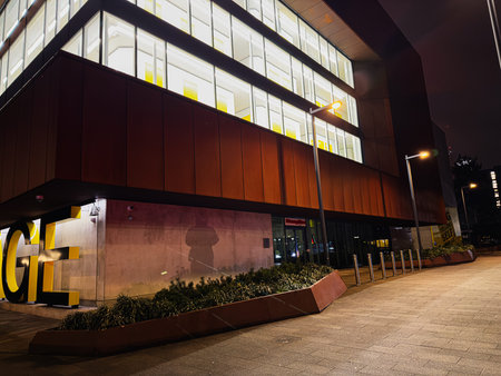 Manchester, UK - January 21, 2026: A sleek  Big Yellow Self Storage office facade in Manchester at night, glass windows glow, urban street lights.のeditorial素材
