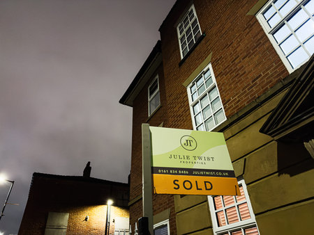 Manchester, UK - January 21, 2026: A sold Julie Twist Properties sign outside a brick building in Manchester, UK, at dusk, indicating a successful property sale.のeditorial素材
