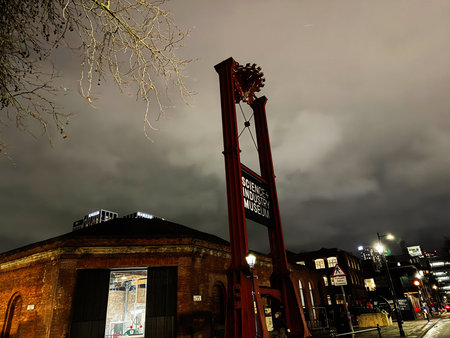 Manchester, UK - January 21, 2026: Night scene of the Science and Industry Museum sign beside a brick building in Manchester, dramatic and moody.のeditorial素材