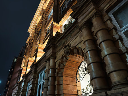 Manchester, UK - January 21, 2026: A lit historic The Tootal Buildings with columns and arches in Manchester at night, showcasing classic architecture and urban charm.のeditorial素材