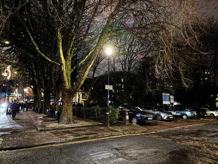 Manchester, UK - January 21, 2026: Moonlit Manchester Stone street with bare trees, parked cars, and warm street lamps creating a quiet urban scene.のeditorial素材