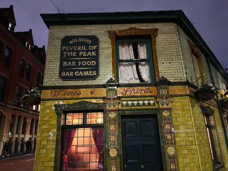 Manchester, UK - January 21, 2026: Nighttime view of a traditional Manchester Peveril of the Peak pub with decorative tiles, ornate trim, and warm interior glow.のeditorial素材