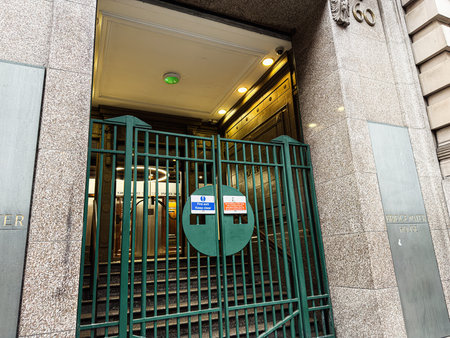 Manchester, UK - January 22, 2026: Entrance to a secured Manchester building featuring a green metal...