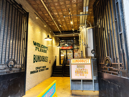Manchester, UK - January 22, 2026: Industrial feel entrance at Bundobust Manchester with craft beer and Indian street food signage and brewing equipmentのeditorial素材