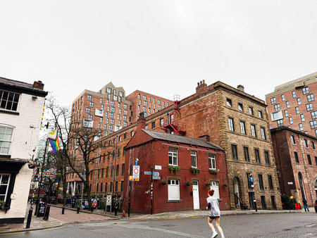 Manchester, UK - January 22, 2026: Urban Manchester scene with brick houses, modern flats, and a jogger on a city Chorlton street.のeditorial素材