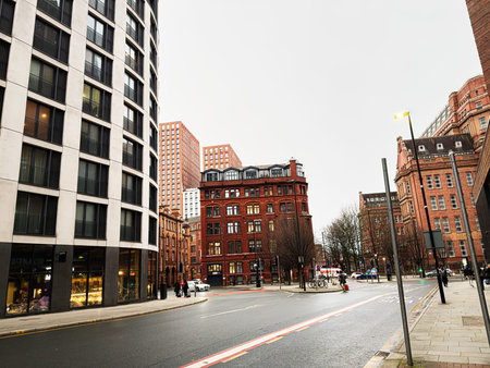 Manchester, UK - January 22, 2026: Busy city street in Manchester showing a mix of red brick and contemporary buildings.のeditorial素材