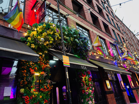 Manchester, UK - January 22, 2026: Vibrant storefront in Manchester features a floral arch, rainbow LGBTQ flags, and twinkling lights.のeditorial素材