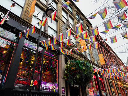 Manchester, UK - January 22, 2026: A lively Manchester street adorned with LGBT rainbow flags, banners, and bright The Brewers.のeditorial素材