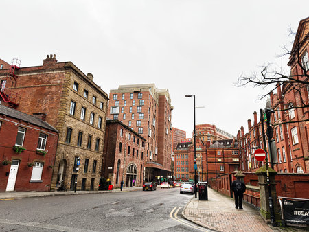 Manchester, UK - January 22, 2026: A street scene in Manchester featuring brick facades, modern...