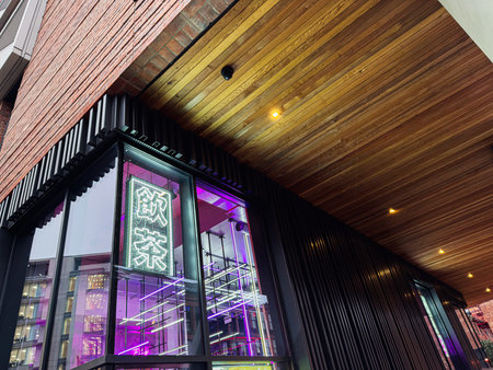 Manchester, UK - January 22, 2026: A stylish urban asian restaurant facade in Manchester featuring neon signage, glass windows and warm lighting.のeditorial素材