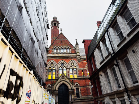 Manchester, UK - January 22, 2026: An old Gothic style Minshull Street Crown Court building sits between contemporary structures on a narrow Manchester street.のeditorial素材