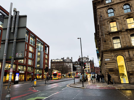 Manchester, UK - January 22, 2026: Urban scene in Manchester showing modern and historic architecture, wet Aytoun street, and people during the evening rush.のeditorial素材