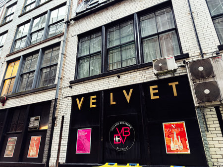 Manchester, UK - January 22, 2026: A stylish Manchester Velvet bar storefront featuring bold gold...