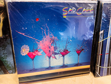 Lviv, Ukraine - February 07, 2026: Bright colorful drinks on a bar against a blue background with pink splash and garnish. Sad CafÃ© 1980 vinyl.のeditorial素材