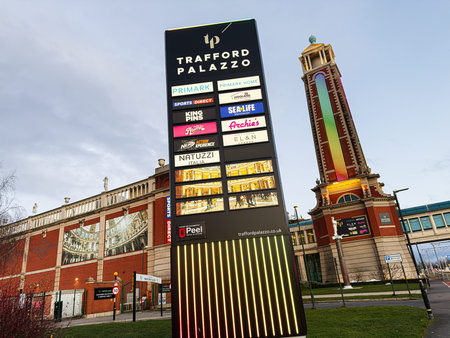 Manchester, UK - January 23, 2026: Iconic Trafford Palazzo signage in Manchester, featuring a tall colorful tower and retail storefronts, vibrant urban scene.のeditorial素材
