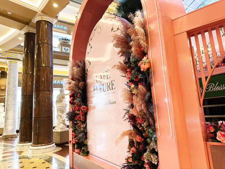 Manchester, UK - January 23, 2026: Elegant pink cafe display with floral arch in a luxury shopping mall in Manchester.のeditorial素材