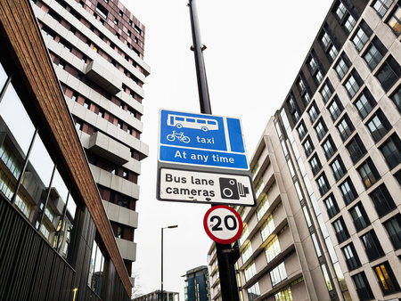 Urban scene in Manchester with traffic signs for bus bike taxi lanes and speed limit.の写真素材
