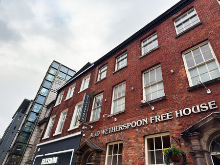 Manchester, UK - January 29, 2026: Brick Wetherspoon pub exterior on a Manchester street, blending...