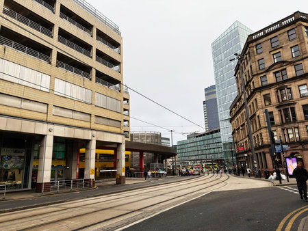 Manchester, UK - January 30, 2026: Busy Manchester street with tram lines, mixed architecture, and...