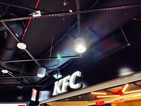 Edinburgh, Scotland, UK - February 15, 2026: Bright KFC illuminated sign with exposed ducts and...