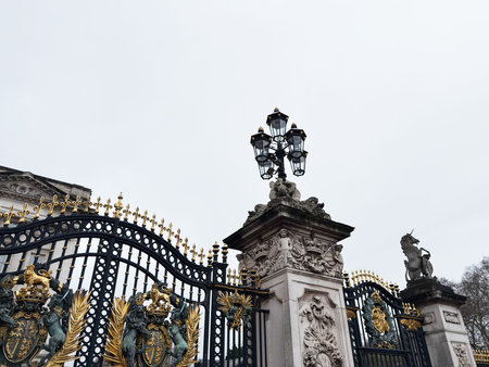 London, UK - February 01, 2026: Luxurious black Buckingham Palace iron gate with gold ornaments, stone pillars, and ornate lamps, a historic landmark in London.のeditorial素材