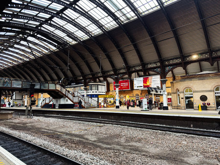 York, UK - February 15, 2026: Busy York train station platform with vaulted roof, shoppers,...