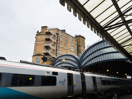 York, UK - February 15, 2026: Modern TransPennine Express train beneath arched iron and glass canopy...